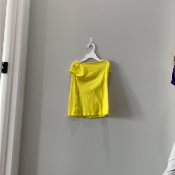 It is a yellow shirt with a flower on it - Picture 2 of 4